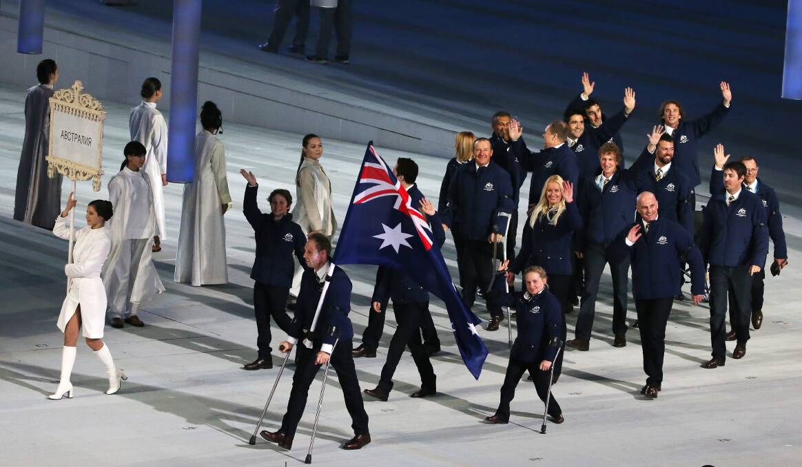 Cameron Rahles-Rahbula, on crutches, leads the Australian team into the Sochi arena for the opening ceremony. Picture: Getty Images
