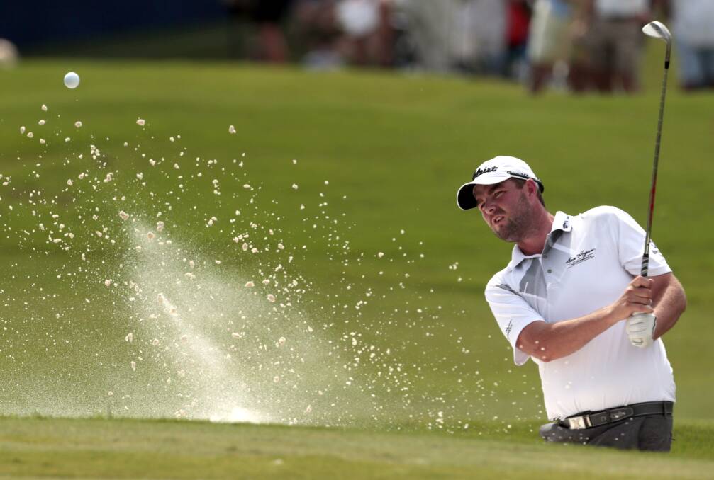 Marc Leishman hits out of a bunker on the 18th hole during the final round of the Zurich Classic. Picture: AP