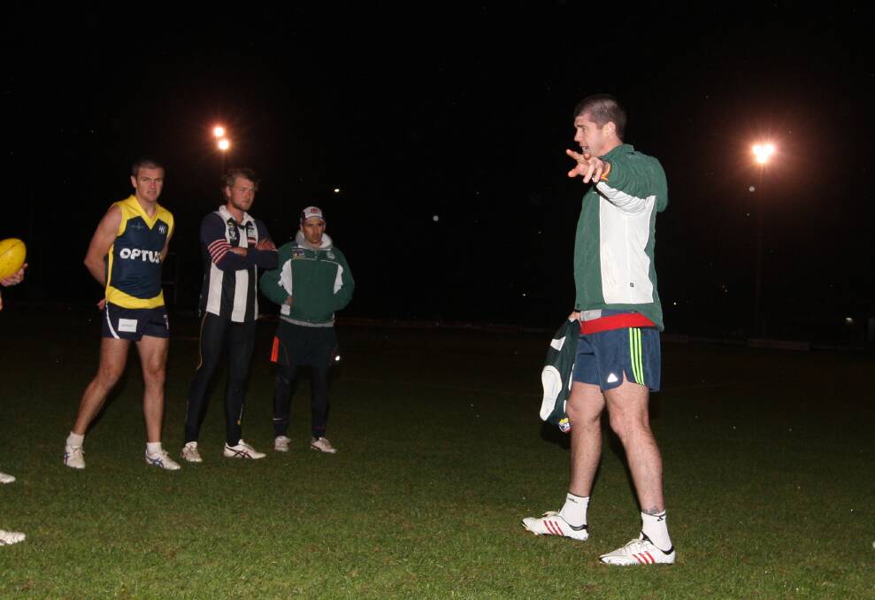Jonathan Brown (right) braves wintry weather to help take Hampden interleague squad training at Reid Oval. 150505AS11 Picture: AARON SAWALL