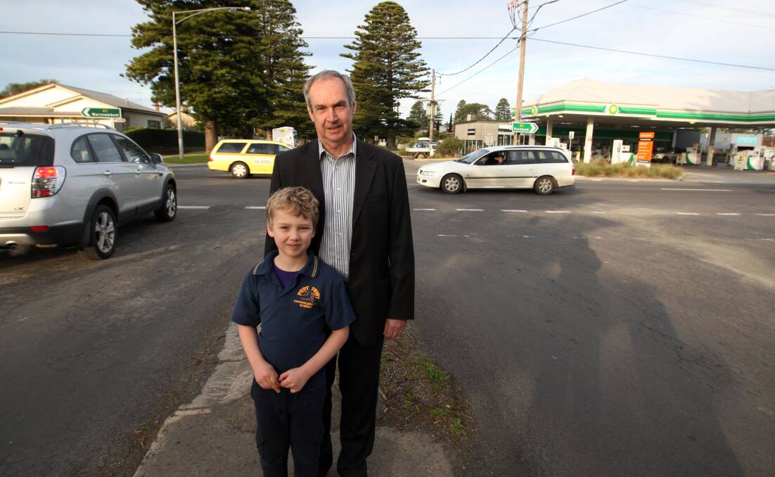 Moyne Shire mayor James Purcell with his grandson Isaac Purcell, 7, at the corner of Regent Street and the Princes Highway in Port Fairy, where there are calls for the installation of the town’s first traffic lights. 140723LP10 Picture: LEANNE PICKETT