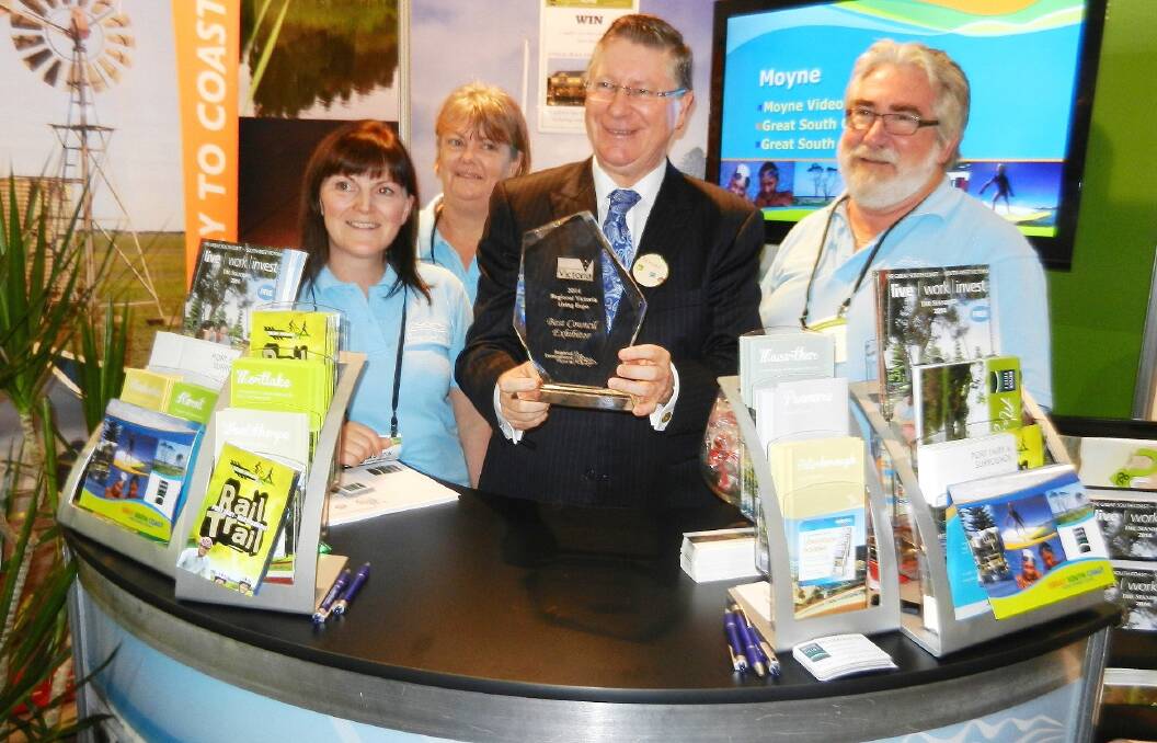 Fancy meeting you here ... Victorian Premier and Port Fairy resident Denis Napthine presents the trophy for Moyne Shire’s award-winning stand at the Victorian Regional Living Expo to shire staff Emma Riddington (left), Dianne McNamara and Mitchell Rowe.