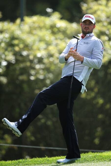 Marc Leishman tries a little body language to convince his putt to drop. Picture: GETTY IMAGES