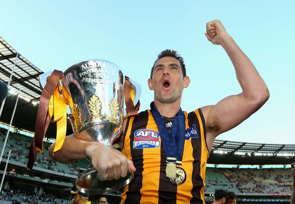 Luke Hodge embraces the 2014 Premiership Cup after Saturday’s demolition of the Sydney Swans at the MCG. Picture: Getty Images