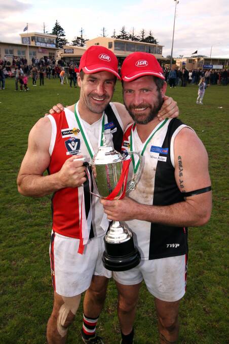 Brothers Chris (left) and Joe McLaren with the ultimate footy reward. 140920DW26 Picture: DIAMIAN WHITE