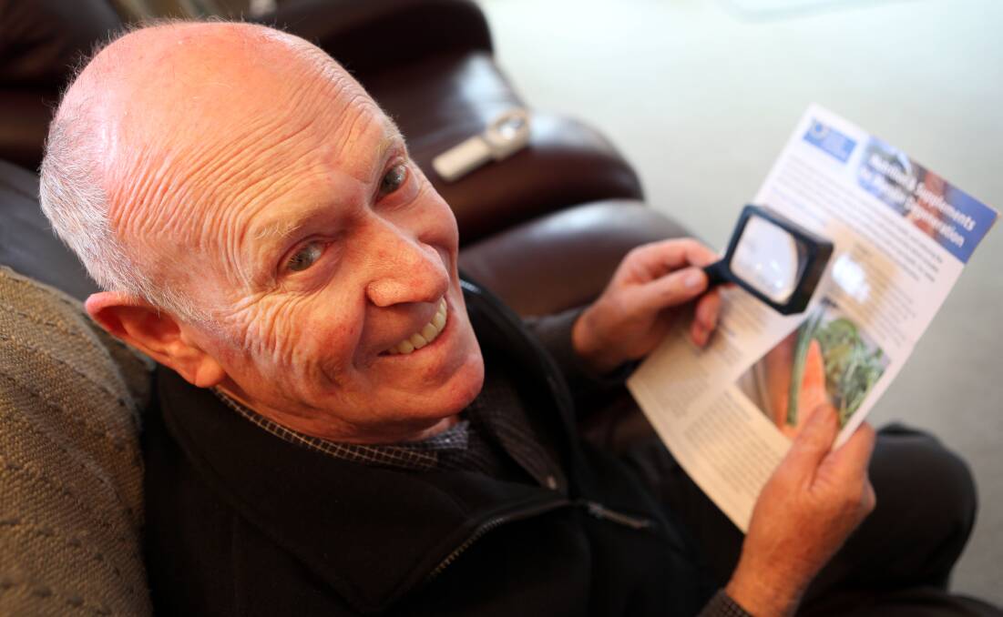 Bryan Mair still enjoys a read, with a little help from magnifying technology. 