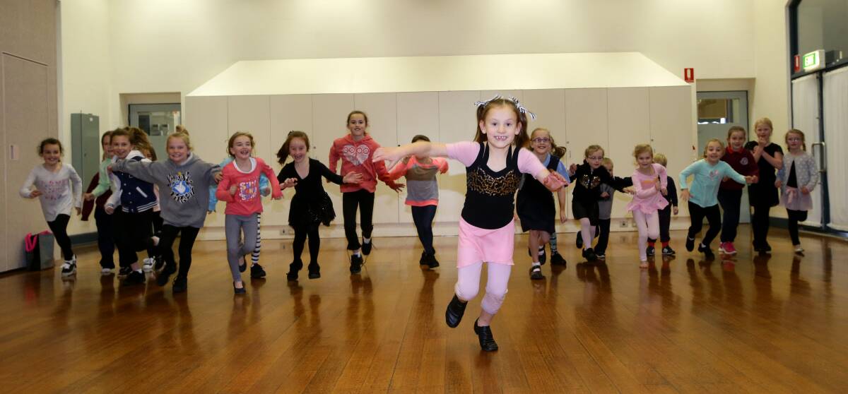 Shaylea Ralston, 7, leads out a group of Bec’s Dance School pupils warming up for the weekend’s Flaggy 5k run, which will support the Leila Rose Foundation. 
140730AS10 Picture: AARON SAWALL