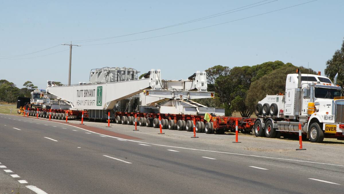 A convoy of prime movers transport equipment to the Macarthur wind farm and Tarrone sub-station. Moyne Shire is seeking funds to repair roads damaged in the construction of the wind farm. 