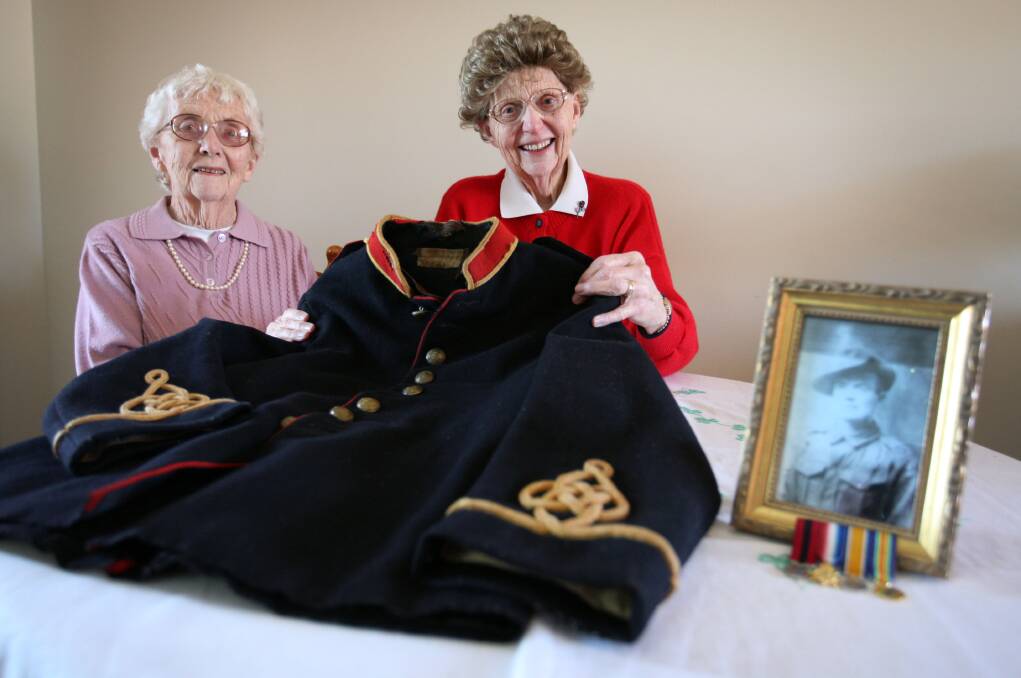 Warrnambool’s Mary Williams (left) and Fonce Murnane with their father Bill Carlin’s dress coat which was part of his Royal Australian Garrison Artillery uniform.140627LP20 Picture: LEANNE PICKETT 