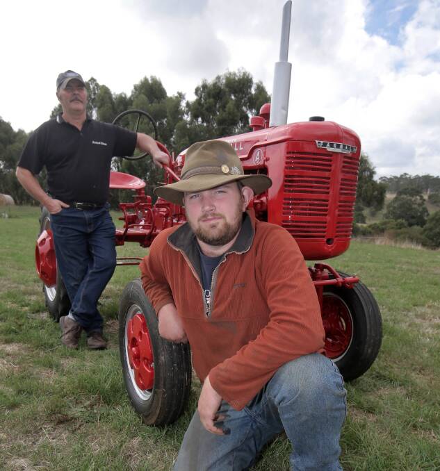 Barry (left) and Adam Edge, both of Laang, with the restored 1940s McCormick Farmall A tractor to be auctioned at the rally.