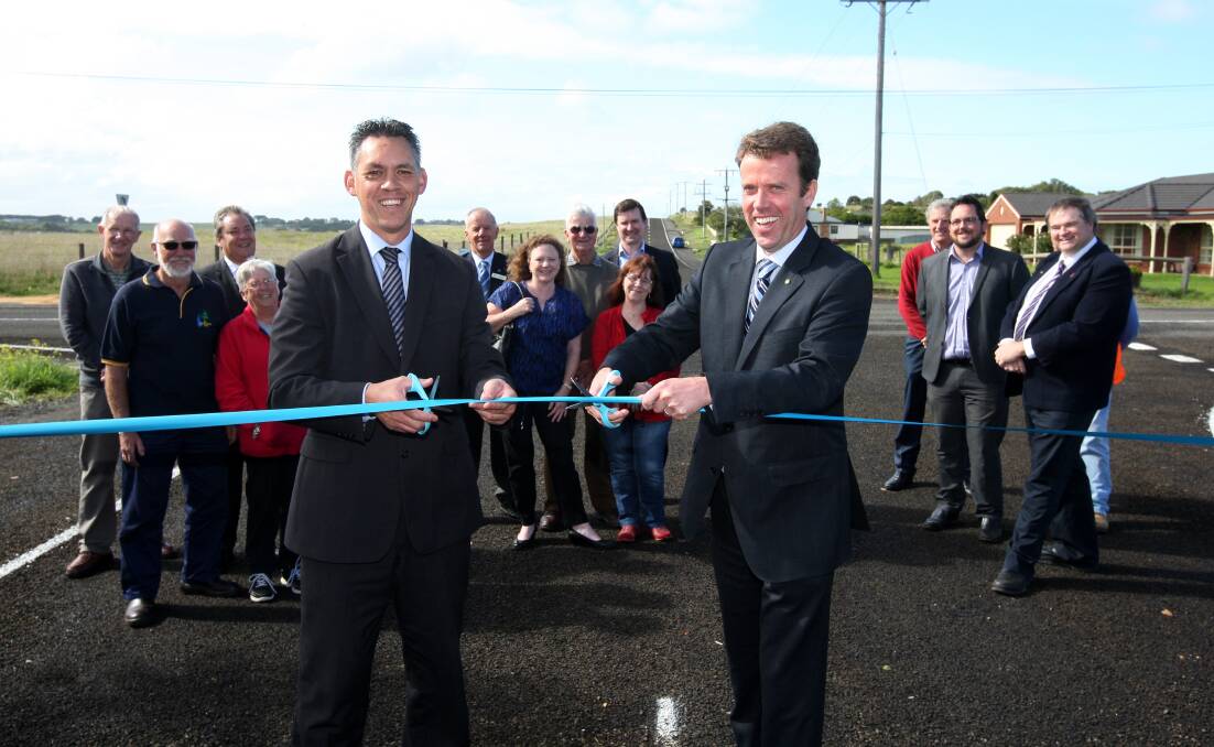 Warrnambool mayor Michael Neoh and member for Wannon Dan Tehan cut the ribbon to officially open the sealed section of Coghlans Road at the Russell Street intersection. 