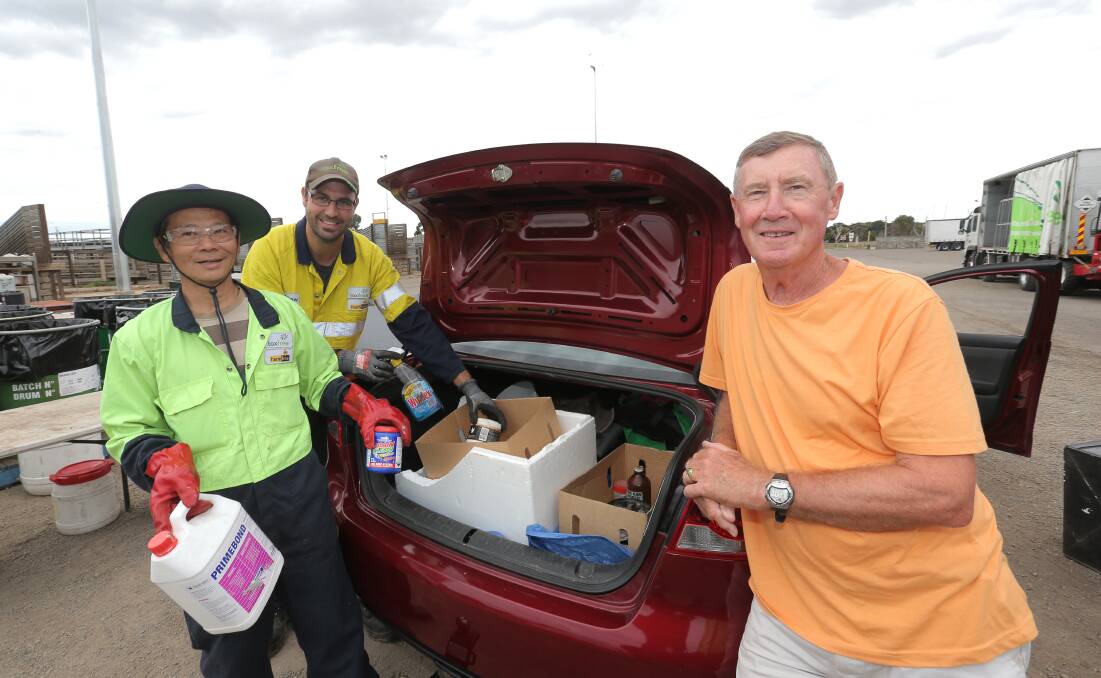 Tony Ly and Matthew Bezzina, from Toxfree, help Warrnambool’s Andrew Fawcett get rid of unwanted household chemicals as part of the annual Detox Your Home day organised by Sustainability Victoria and the city council. 150228VH06 Picture: VICKY HUGHSON