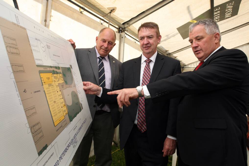 Chairman of the Peterborough Residents Group, Ron Irvine (left), member for Polwarth Terry Mulder and Moyne Shire deputy mayor Colin Ryan inspect the hall plans at yesterday’s funding announcement in Peterborough. 141023LP20 Picture: LEANNE PICKETT