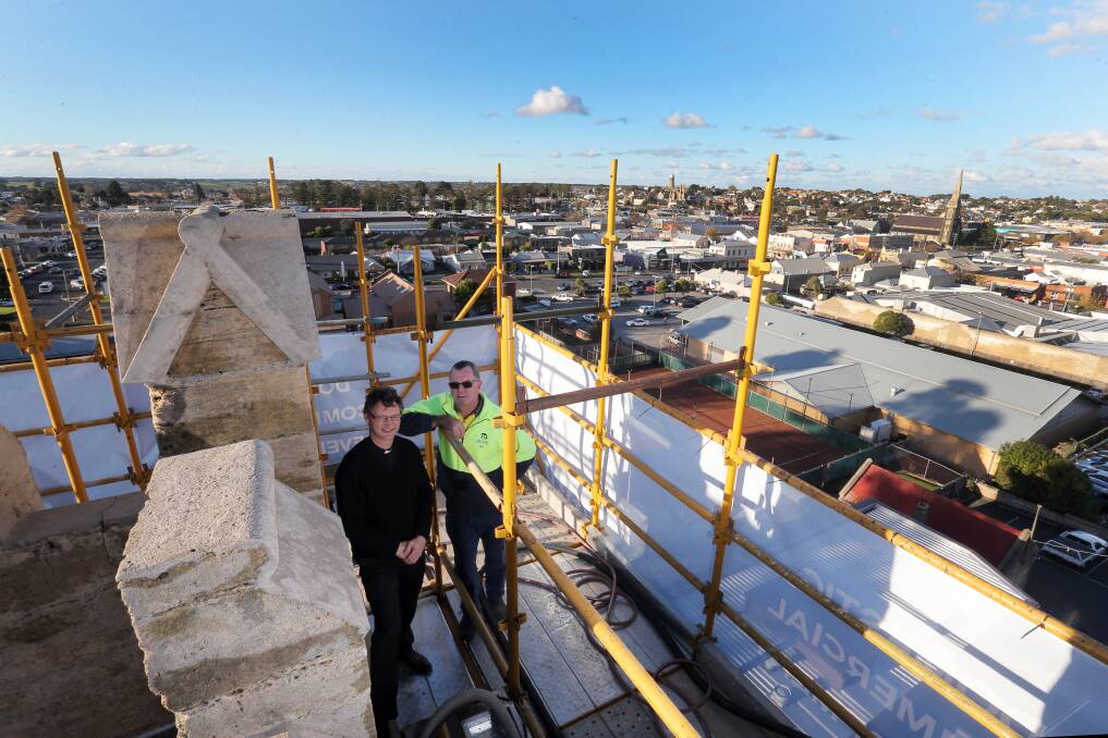 Father Scott Lowery and builder Ian Bolden admire the panorama from atop Warrnambool Christ Church’s bell tower, which is encased in scaffolding while undergoing restoration and preservation work. 150519RG04 Picture: ROB GUNSTONE