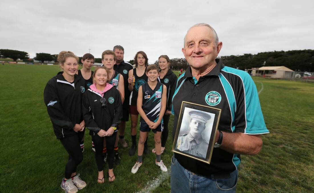MAIN: Ron Holmes with a photo of his uncle Albert Holmes who died at the Somme, flanked by Albert’s relatives who are all part of the Kolora-Noorat Football and Netball Club.150423AS20 Picture: AARON SAWALL