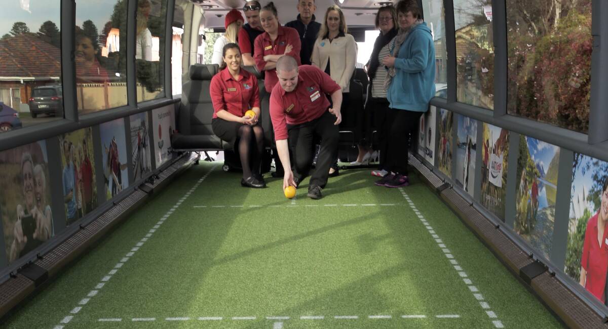 Warrnambool Bowls Club staff member Dylan Barling tries his hand at indoor bus bowling during a promotional visit by the customised AAT Kings coach at the club. 140723RG21 Picture: ROB GUNSTONE