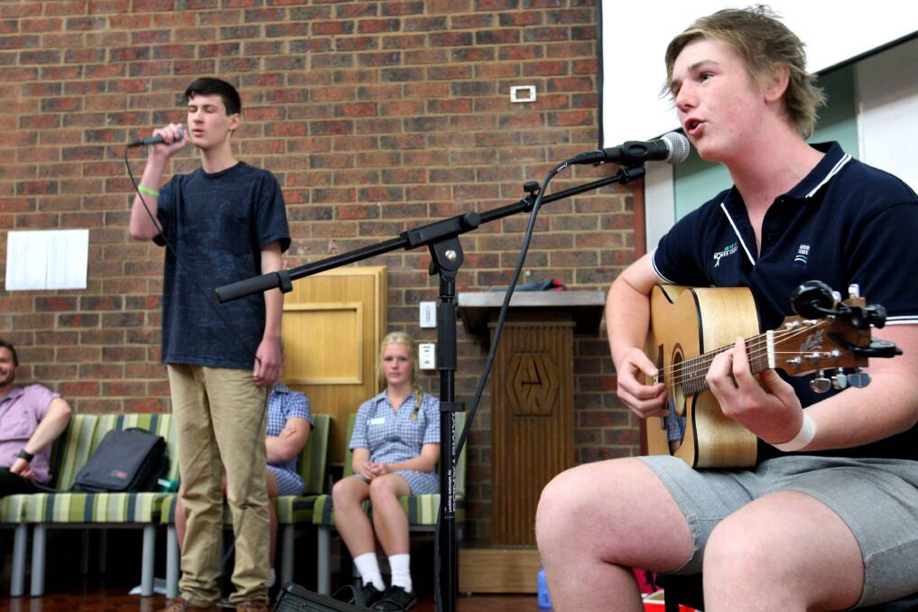 Mortlake College students Jacob Pugh, 15, (left) and Cooper Lower, 16, entertain at yesterday’s gathering  150227LP08 Picture: LEANNE PICKETT