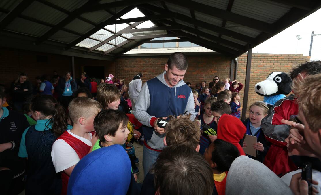 Jonathan Brown signs autographs at yesterday’s AFL9s clinic in Warrnambool. 140917VH01 Picture: VICKY HUGHSON