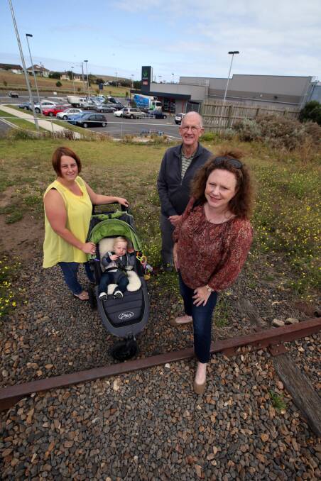 Caz Murrell and her son Mason (11 months) with Dennington Community Association president David Kelson and Cr Kylie Gaston at the rail line.