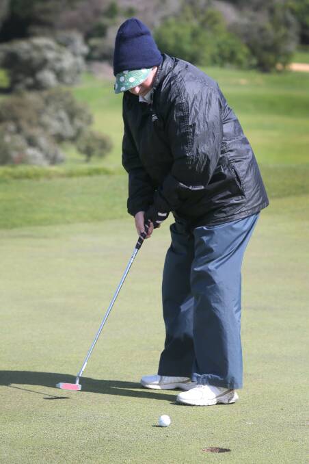 Timboon golfer Gloria Wigley stayed all rugged up against a chill wind despite a rare burst of sunshine while putting in the teams competition. 140917RG07 Picture: ROB GUNSTONE