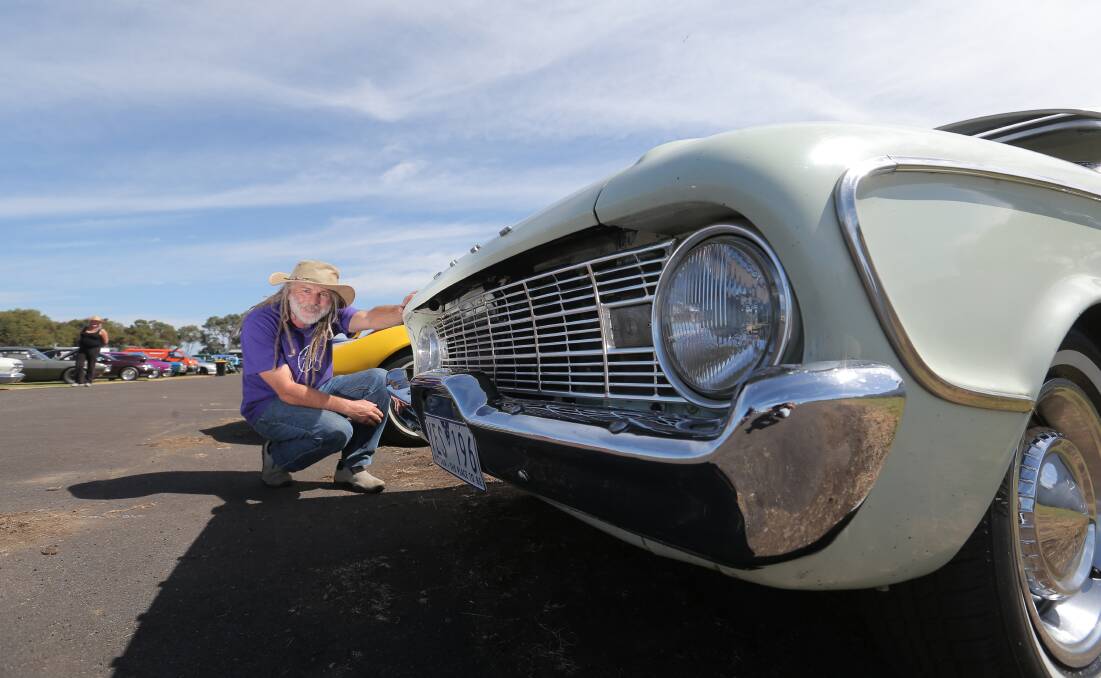  Warrnambool’s Wes White checks out this Ford Falcon at Koroit yesterday.  150322VH02 Picture: VICKY HUGHSON