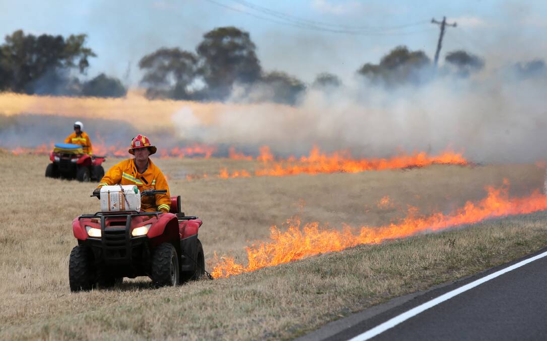 CFA volunteers work at burning the roadside verge along the Hamilton Highway between Darlington and Derrinallum this week to control the risk of larger fires as summer approaches. 141217RG26 Picture: ROB GUNSTONE