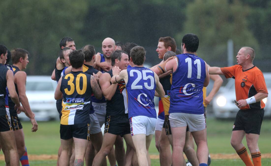 North Warrnambool Eagles and Terang Mortlake players get a little hot and bothered despite cold, wet weather during Saturday's fiery opening round match. 150418VH40 Picture: VICKY HUGHSON
