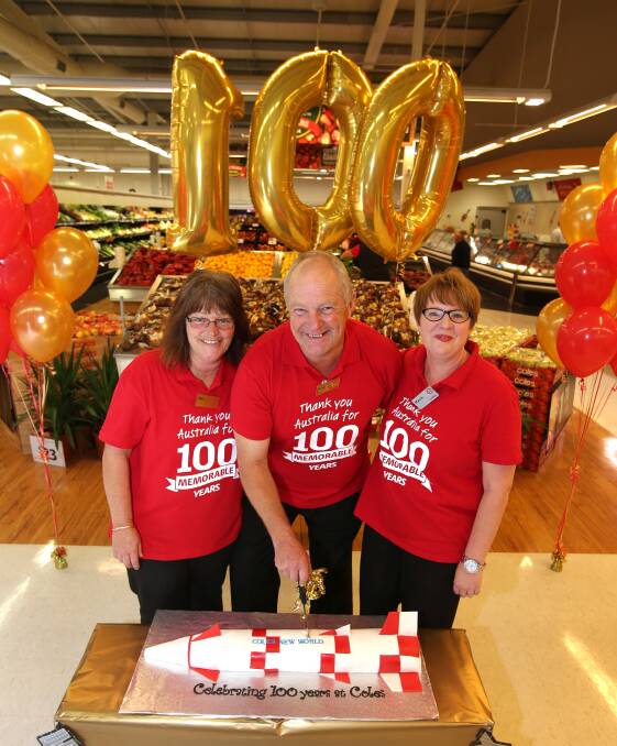 Long-serving staff members Sue Doukas, Peter Townsend and Marcie Pitts shared the honour of cutting Cole’s centenary cake in Warrnambool yesterday.