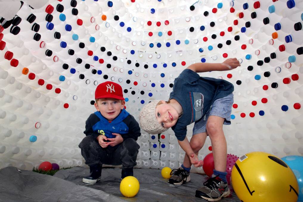 Noah Burgess, 3, and Hudson Greene, 4, test out the recycled milk bottle igloo at Warrnambool’s Honey Pot Childcare Centre. 140623LP06 Picture: LEANNE PICKETT