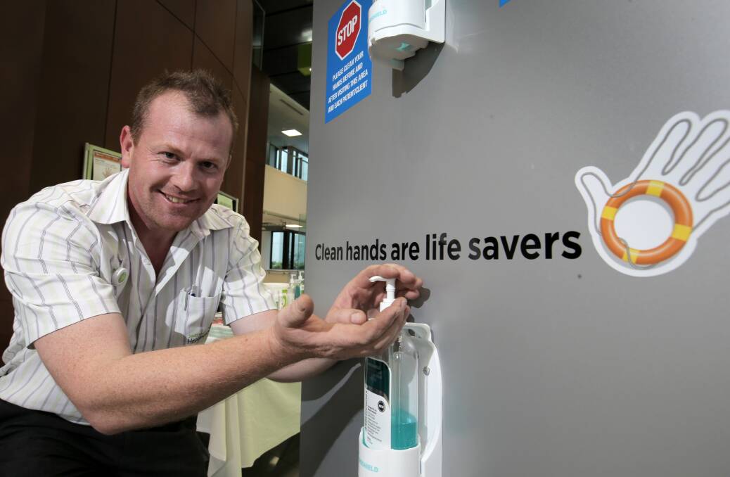 Infection control nurse Joel Chadwick sanitises his hands in the foyer of South West Healthcare. 140504RG07 Picture: ROB GUNSTONE