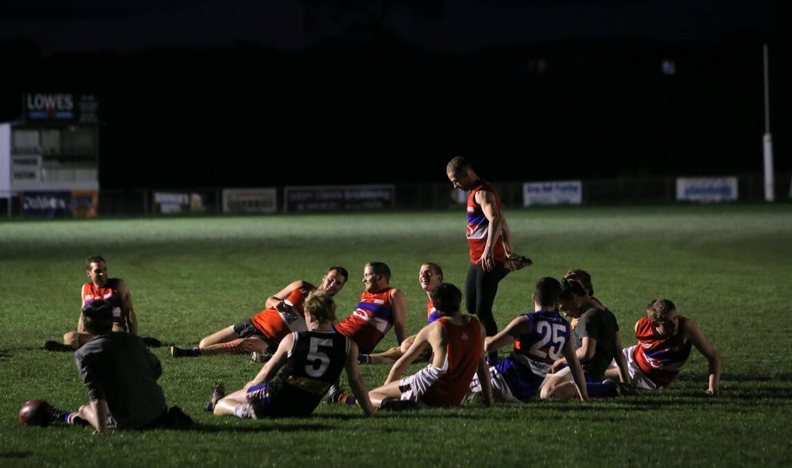 Panmure coach Simon O’Keefe leads his troops in some stretches at training last night.140904AS25 Picture: ALEX SINNOTT