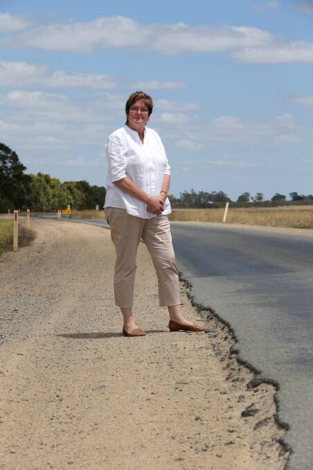 Corangamite Shire councillor Ruth Gstrein stands at the sharp, crumbling shoulder of Foxhow Road. She has called for urgent state funding for repairs to prevent a serious accident.
150128DW27 Picture: DAMIAN WHITE