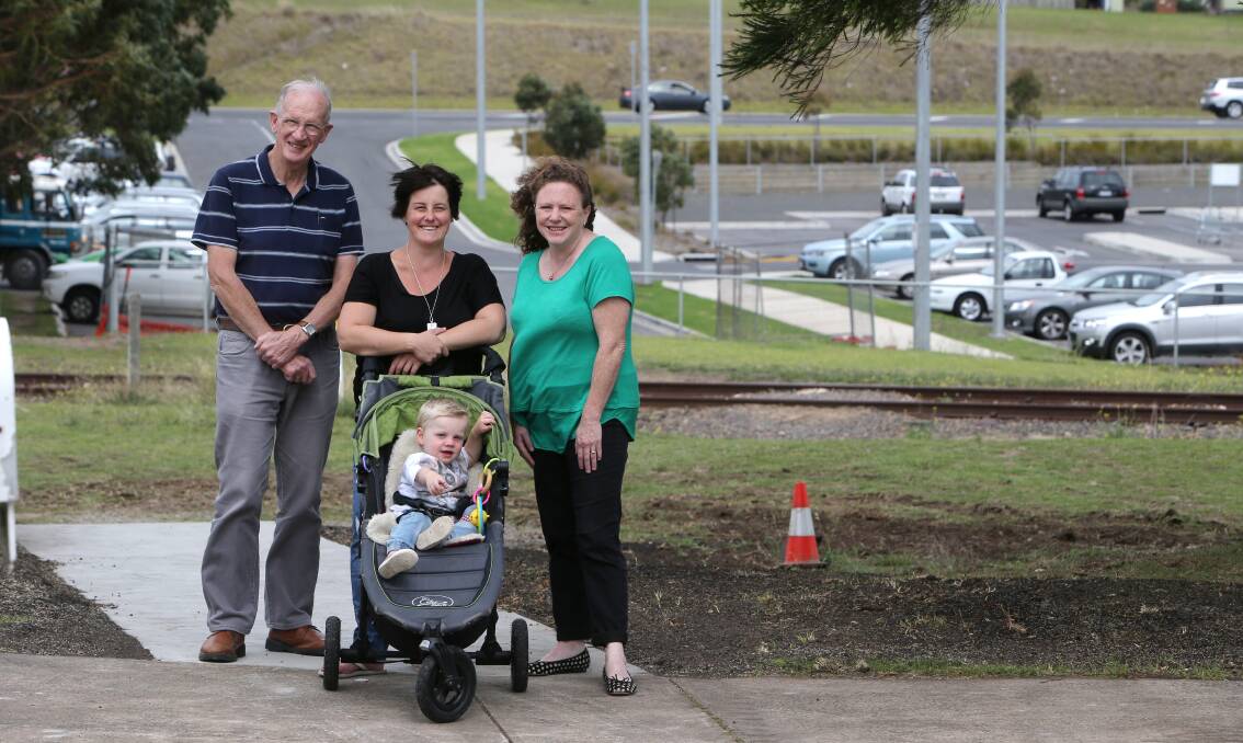 Dennington Community Association president David Kelson, resident Carolyn Murrell (with son Mason, 23 months) and Cr Kylie Gaston inspect the near-complete pedestrian crossing yesterday. 150401AS22 Picture: AARON SAWALL