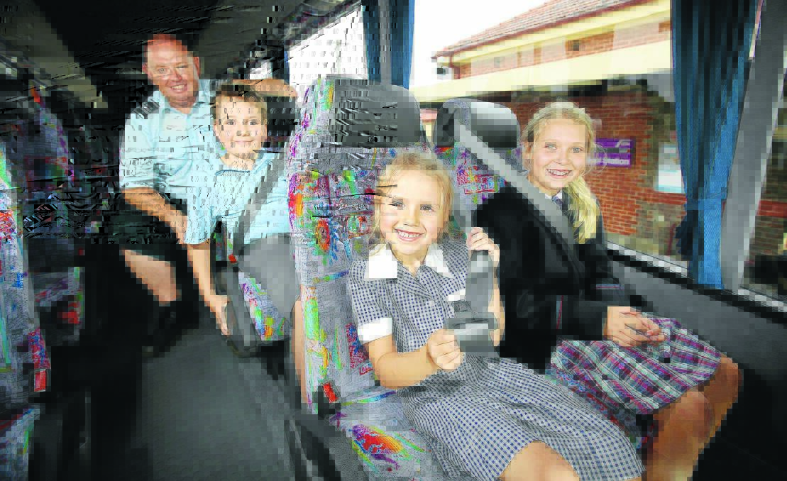 Warrnambool Bus Lines driver Stephen Uebergang ensures children Campbell Crichton, 10, and his sisters Ava, 6, and Ella, 12, are safe and secure. 