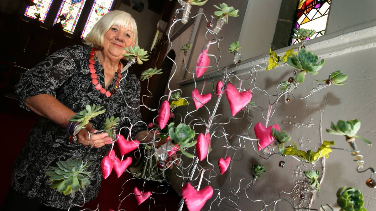 Sally Hallowell, from Koroit Floral Art Group, shows off her creation for this weekend’s festival of flowers.