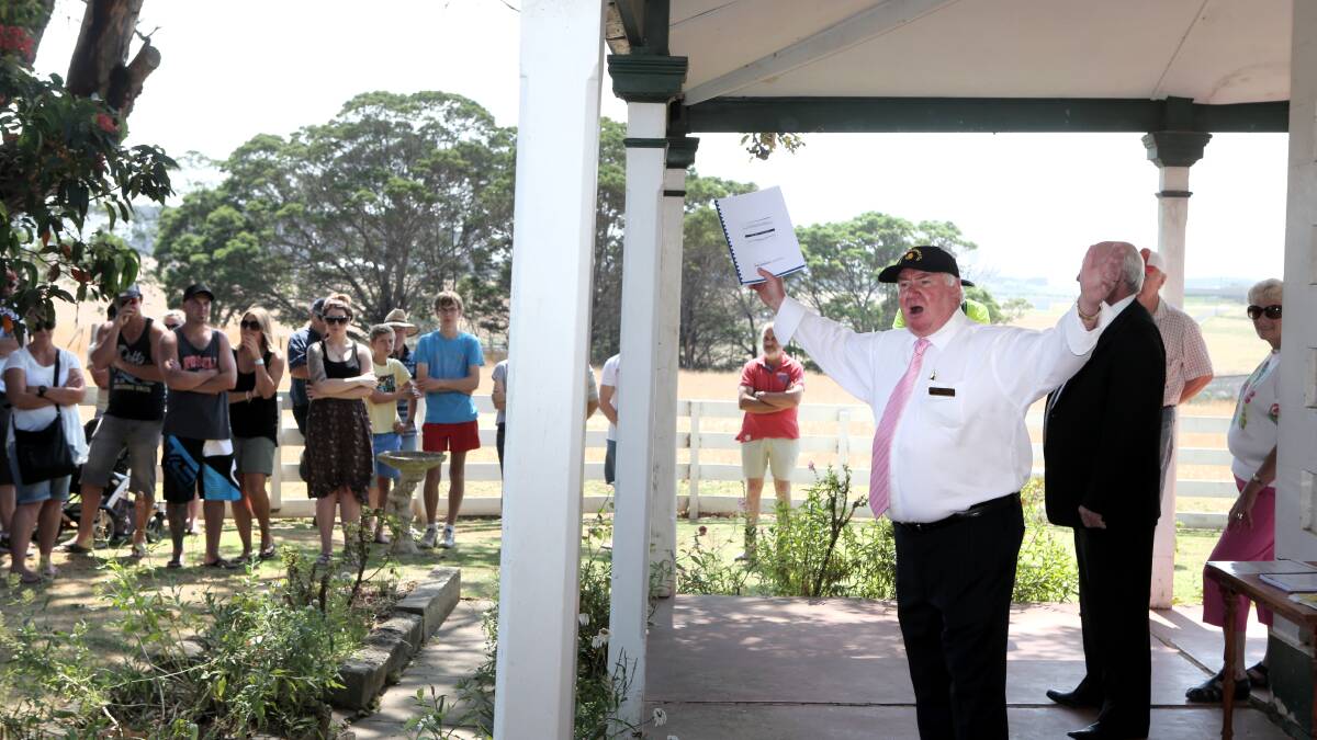 Auctioneer Brian Hancock vainly seeks a bid for historic Summer Hill homestead on Saturday. 