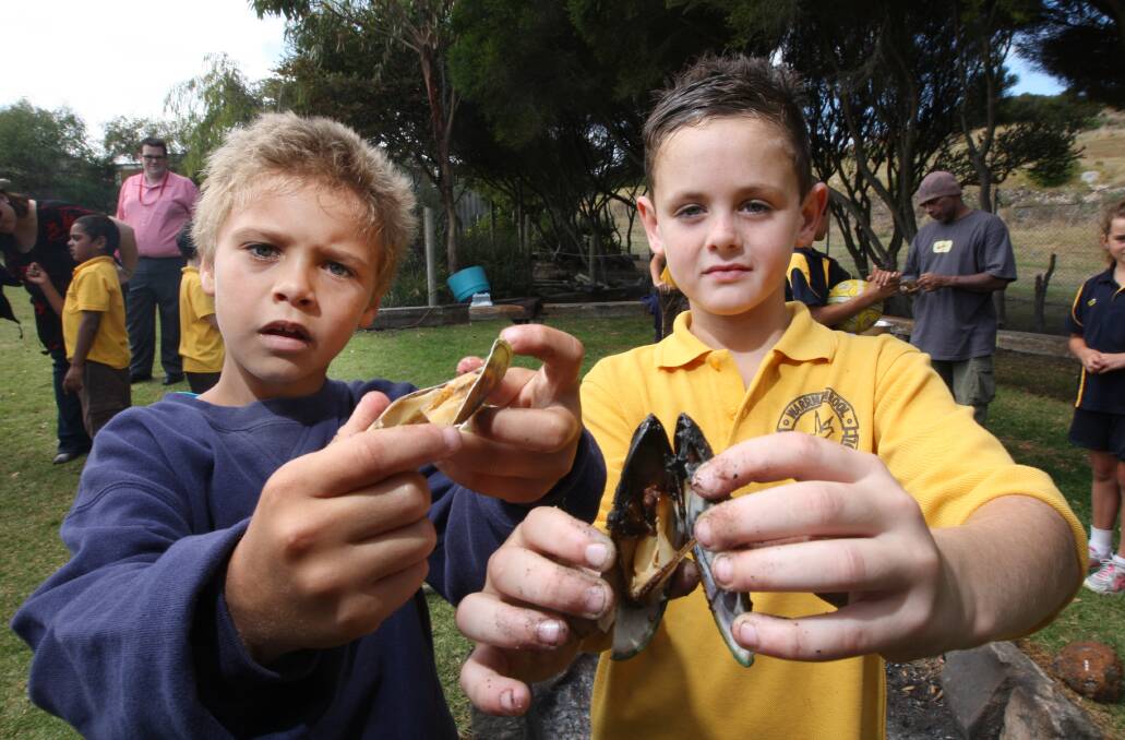 Warrnambool West Primary School pupil Rickey Atkinson, 7, (left)and Jandamara Edwards, 9, from Warrnambool Primary School, prepare to tuck into some mussels yesterday.