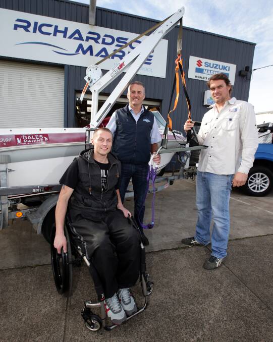 Bryn Murfett can now go fishing after Andrew Westlake (centre) fitted a spitz lift to Bryn’s boat and Edward Richardson, owner of Richardson Marine, fitted a boat catch mechanism. Picture: DAMIAN WHITE