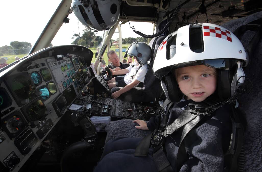 Woodford Primary School prep pupil Taleah Murfett, 6, tries the HEMS 4 cockpit for size during yesterday's visit. Picture: ROB GUNSTONE