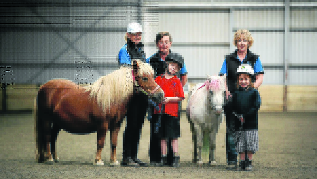 Warrnambool Riding Develops Abilities volunteers Colleen Fawkes (left), Sharyn van Someren and Brenda Hetherington with pupils from Warrnambool Special Development School Faye Carty, 7, and Monique Fleming, 8, at Highview Horse Stud. 