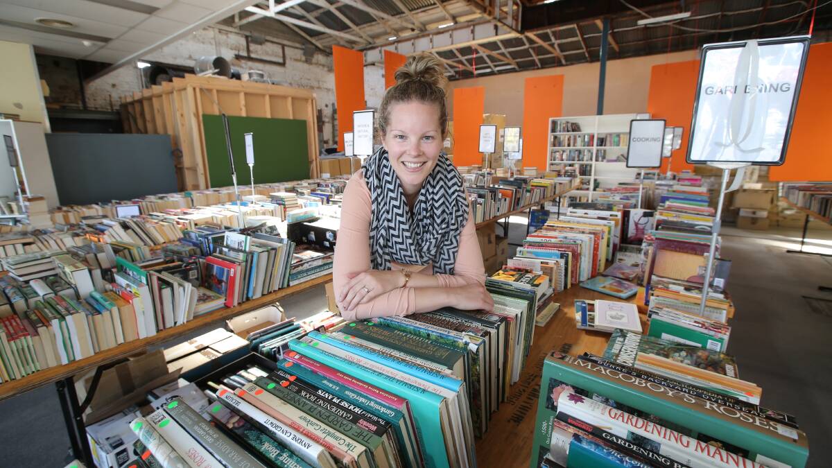 Lifeline’s manager community engagement, Carly Dennis, checks over the hundreds of donated books. 
150331VH30 PICTURE: VICKY HUGHSON