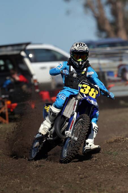 Brauer College student Harley Stutchbery accelerates out of a turn in a 125cc race. 150501DW52 Pictures: DAMIAN WHITE