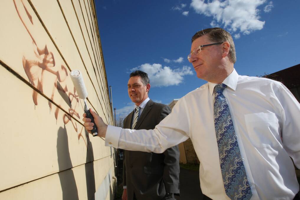 Premier Denis Napthine and Warrnambool mayor Michael Neoh get rolling on the new laneway art project targeting graffiti.             140822LP26 Picture: LEANNE PICKETT