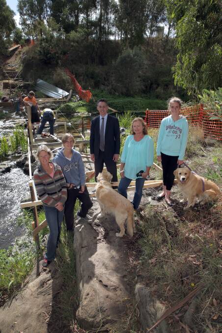 Woodford resident Yvonne Lefebure (front left), Alex Jones, 17, mayor Michael Neoh, Friends of Jubilee Park chairwoman Tricia Blakeslee with Monique Jones, 14, at the site of the new bridge over the Merri River that provides safe pedestrian access to Jubilee Park at Woodford. 150402RG03 Picture: ROB GUNSTONE
