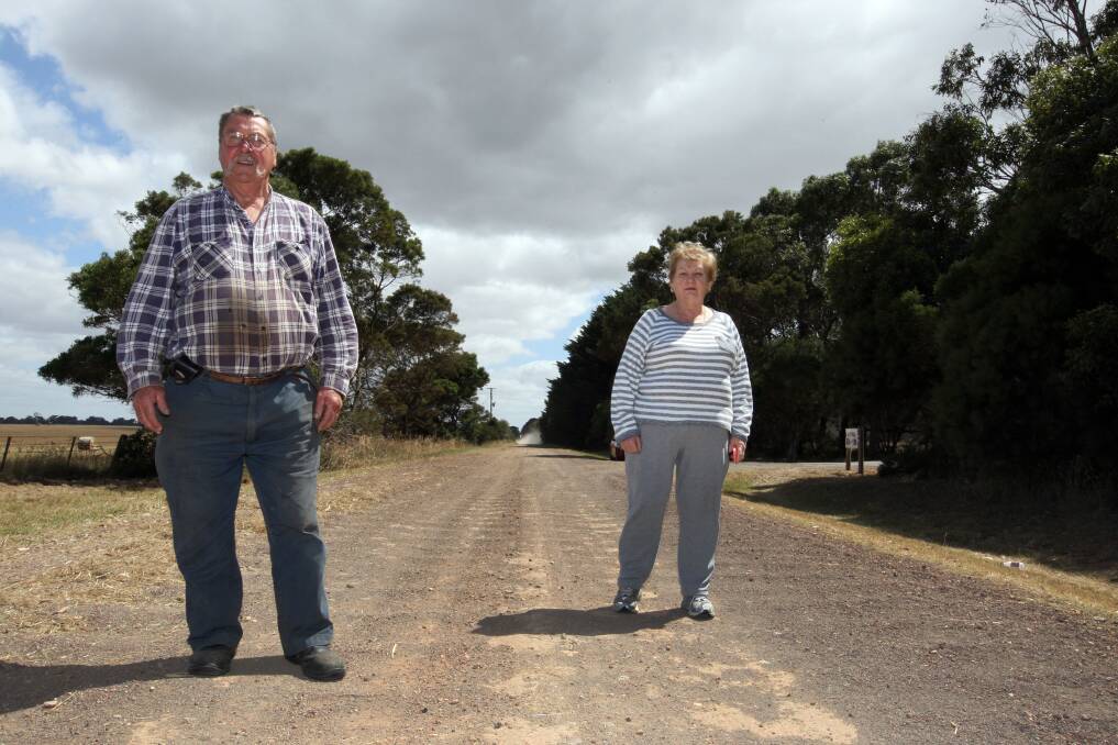 Wiggs Lane neighbours Barry Brown and Glenys Fleming say the busy, rutted road needs sealing. 141217LP02 Picture: LEANNE PICKETT