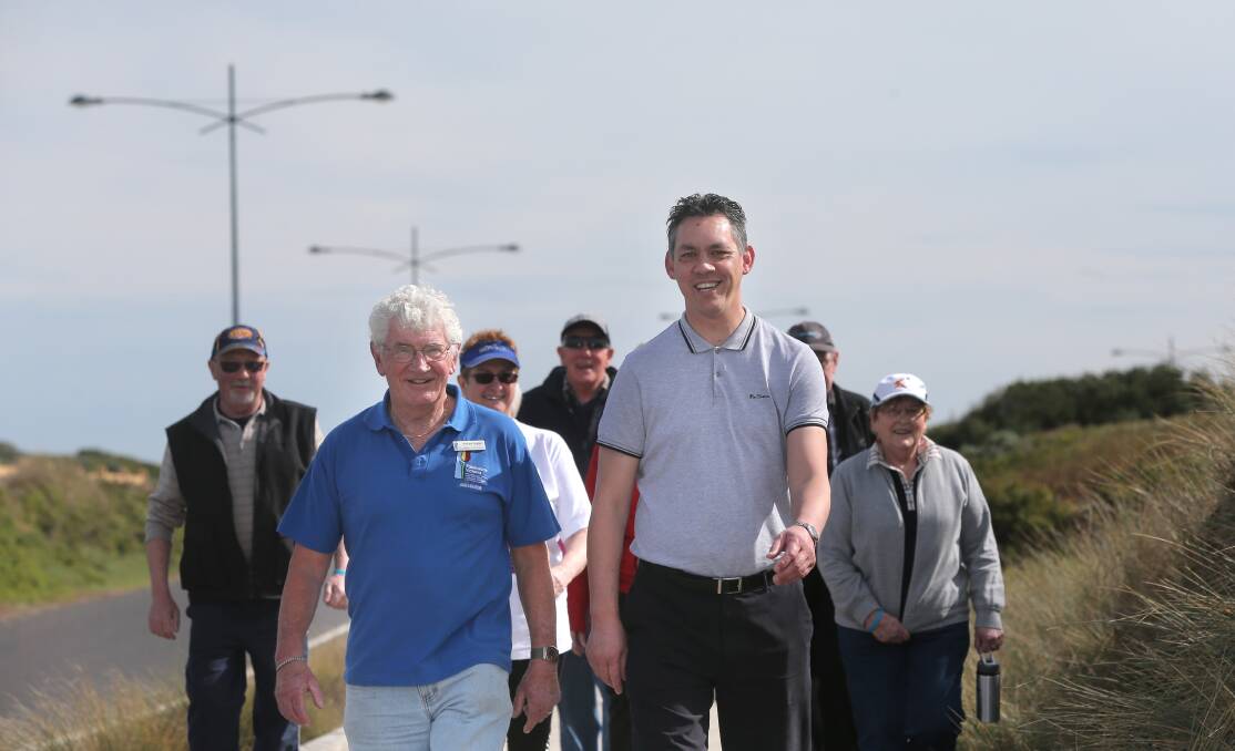 Local support group co-ordinator and vice-president of Parkinson’s Victoria Andrew Suggett (left) with Warrnambool mayor Mike Neoh hit Warrnambool’s foreshore promenade with other walkers in support of Parkinson’s disease awareness on Sunday. 140831VH43 Picture: VICKY HUGHSON