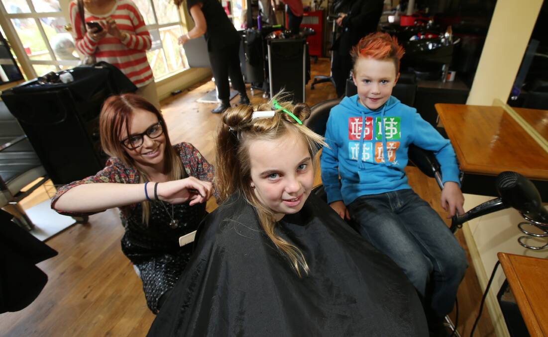 Warrnambool hairdresser Ema Anderton, from A Cut Above, was giving free haircuts to Eden Anderton, 9, and Lewis Duerden, 6, in support of the Good Friday appeal.  