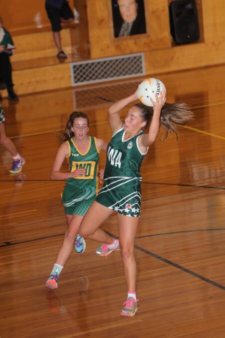 Hampden’s Zoe Bussell rises above her Colac and District opponent Claudia Wiseby to win possession.  Picture: AARON SAWALL