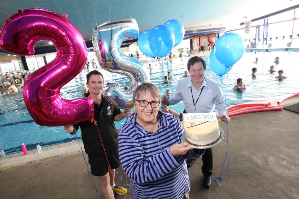 AquaZone’s 2.5 millionth visitor, Elaine Hill, went home with a cake and balloons after her surprise greeting yesterday by program co-ordinator Jason Moloney (left) and service manager Ray Smith. 
140909VH01 Picture: VICKY HUGHSON