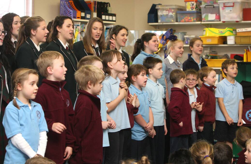 Brauer College students lend their vocal skills to youngsters at East Warrnambool Primary School yesterday in preparation for an Australia-wide event in October. 140805AS05 Picture: AARON SAWALL