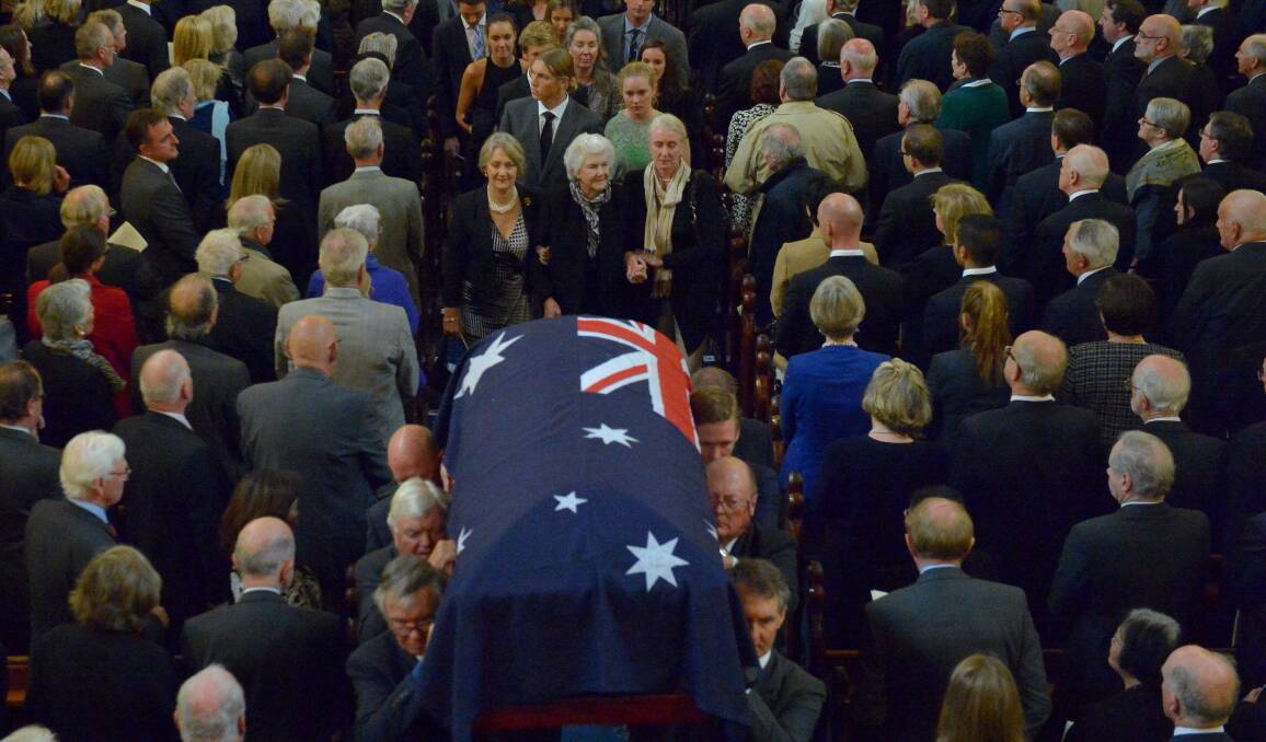 Malcolm Fraser’s widow Tamie follows as her husband’s coffin is carried out of Melbourne’s Scots’ Church after yesterday’s state funeral.Picture: THE AGE